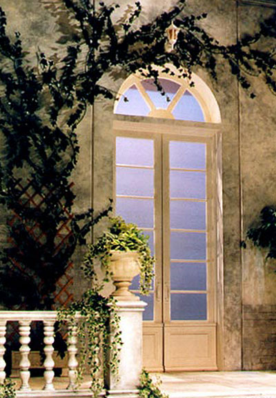 view of stage set - a stone balustrade with a stone urn at its end. Ivy grows in the urn.