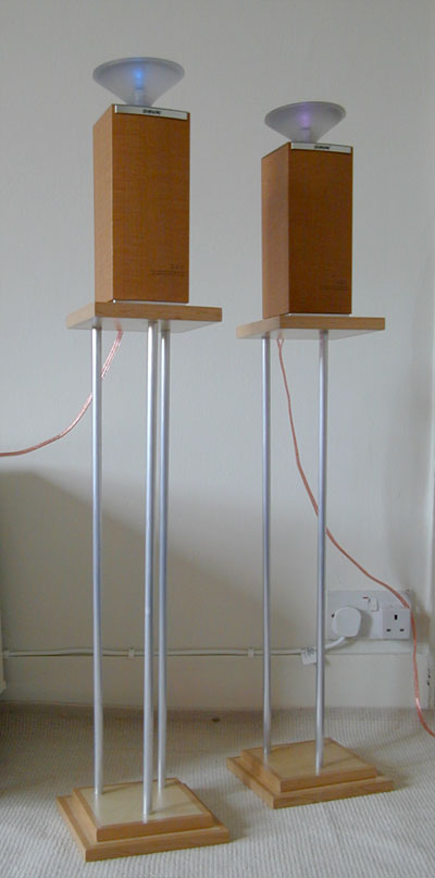 A matching pair of tall speaker stands with three aluminium supports